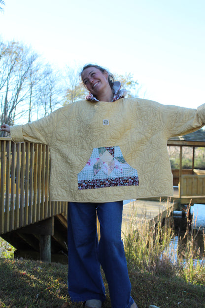 Handmade yellow hoodie with floral embroidered accents and patterned pockets and hood