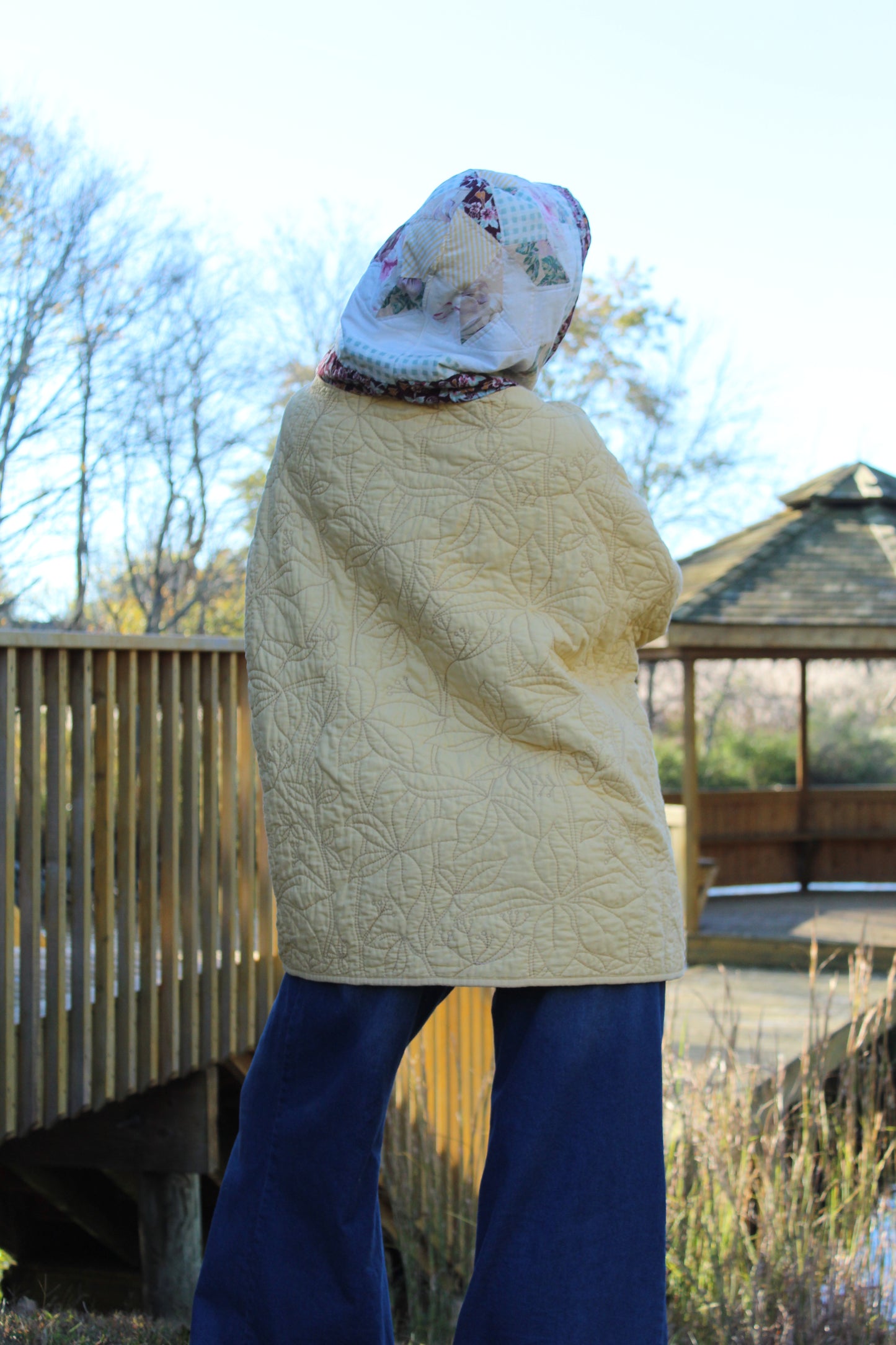 Bright yellow hoodie with delicate floral stitching and coordinating patterned accents