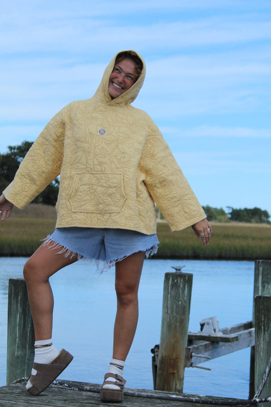yellow stitched quilted sweatshirt with hood and front pocket