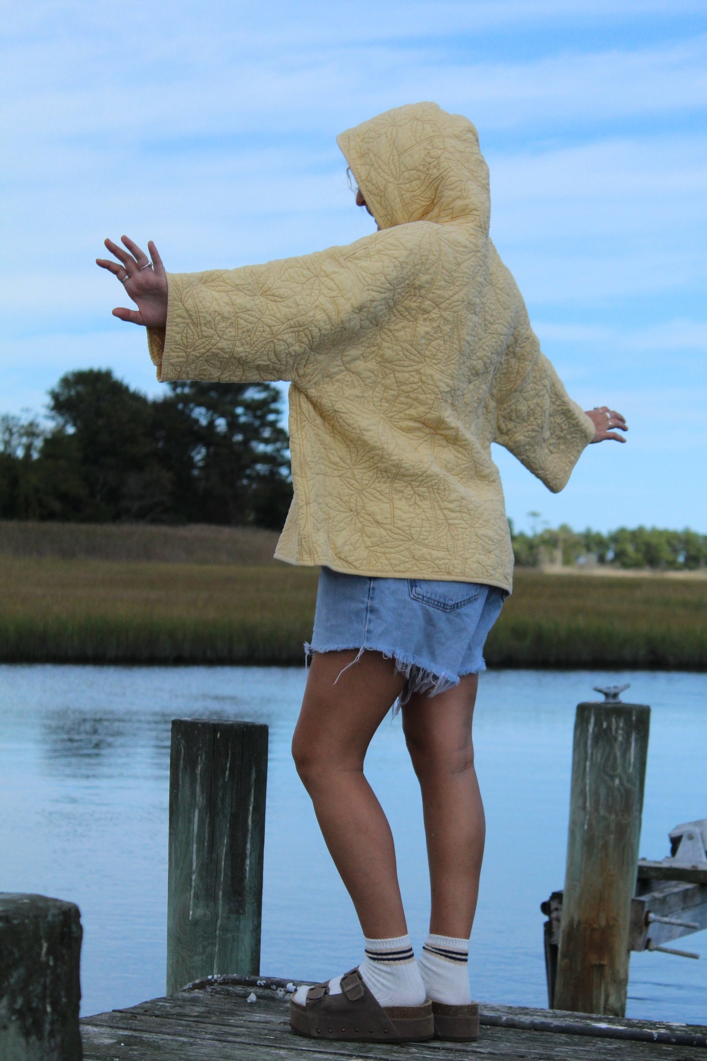 back of yellow quilted hoodie with floral stitched details